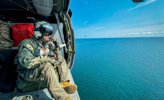 ALPENA, Michigan (Aug. 13, 2024) Naval Aircrewman (Helicopter) 1st Class Miguel Velez, assigned to the "Pioneers" of Air Test and Evaluation Squadron (VX) One, searches for contacts in a MH-60S helicopter during a joint defense training exercise in Alpena, Michigan, during Northern Strike, Aug. 13, 2024. Northern Strike, one of the Department of Defense's largest reserve components, is the premier reserve component training event designed to build readiness with joint and partner forces in all domains of warfare. (U.S. Navy photo by Mass Communication Specialist 1st Class Juel Foster)